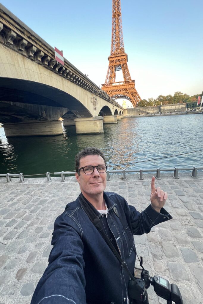 Portrait of Paris photographer Pierre Sattin by the Seine near Eiffel Tower