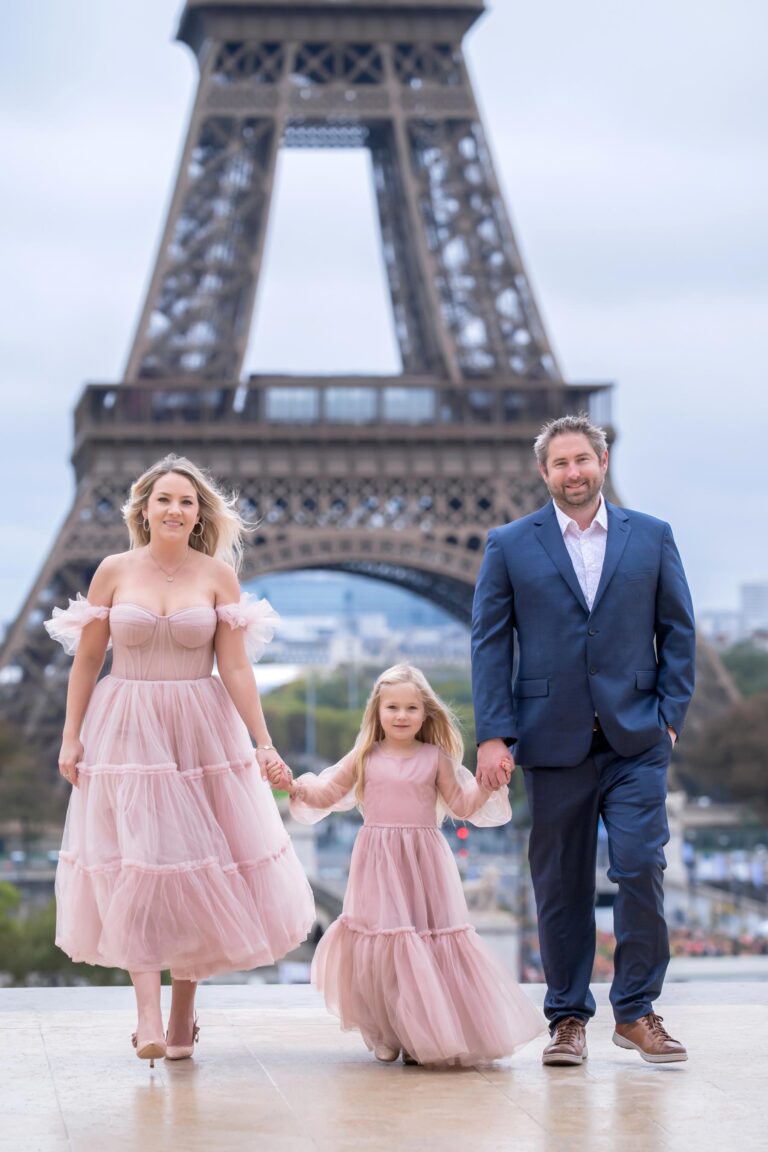 Family with daughter in pink dress walking at Trocadéro during Paris photoshoot