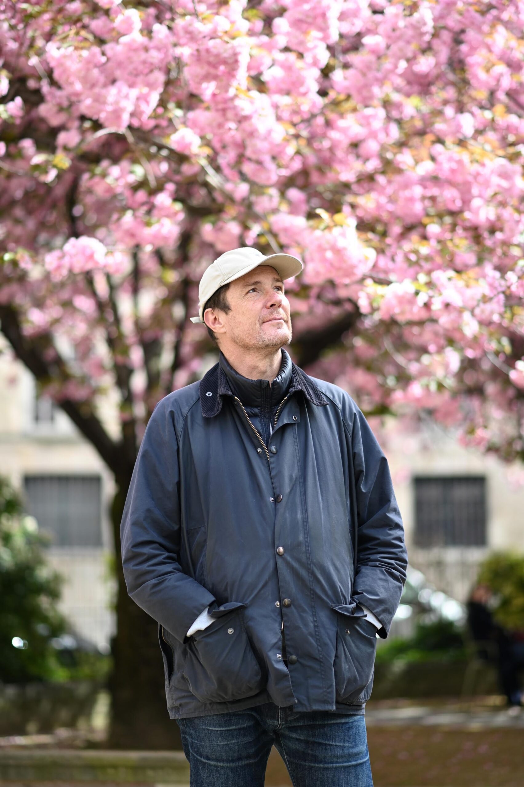 Close-up portrait of Paris photographer Pierre Sattin during cherry blossom season in Paris