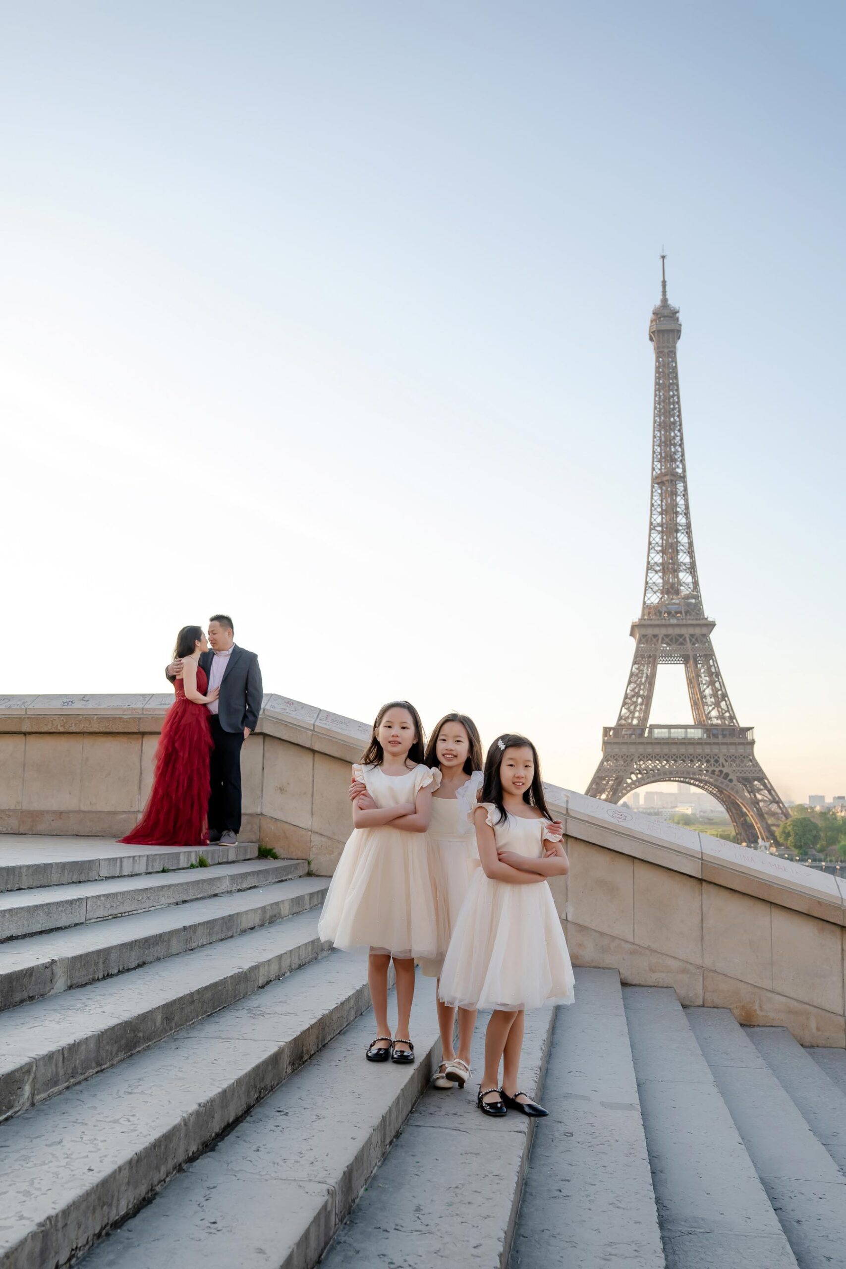 Family at Trocadéro stairs with Eiffel Tower during Paris family photoshoot