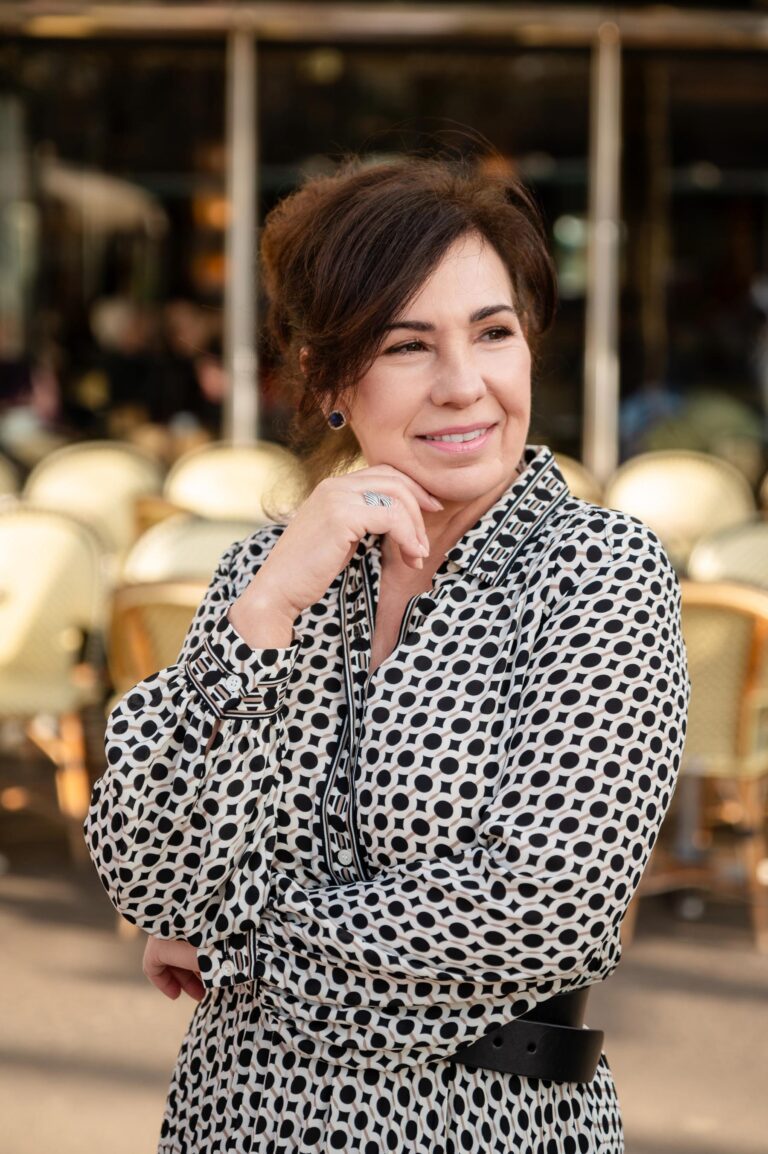 Woman portrait in front of Paris café during solo photoshoot