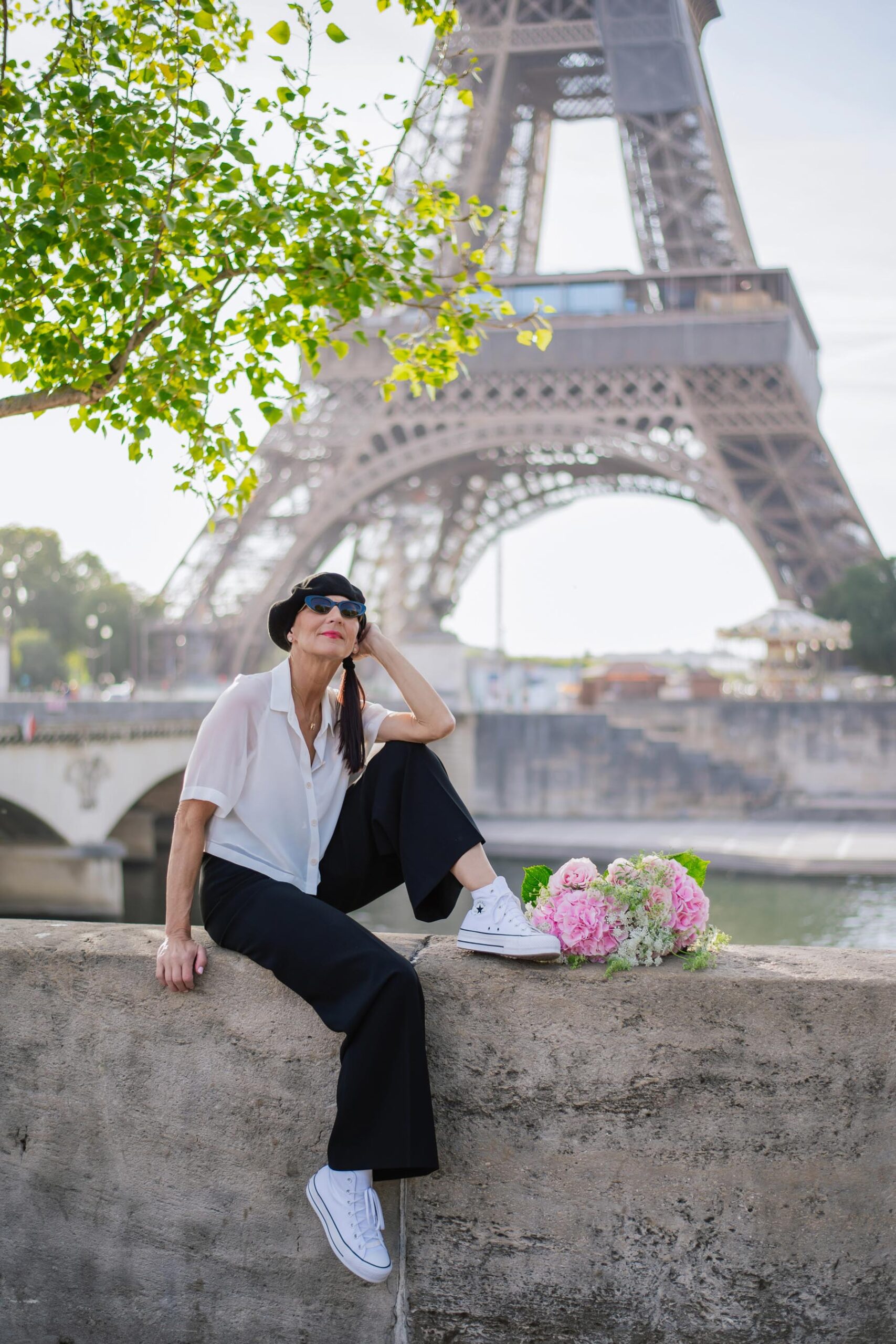 Solo traveler portrait by the Seine river with Eiffel Tower during Paris photoshoot