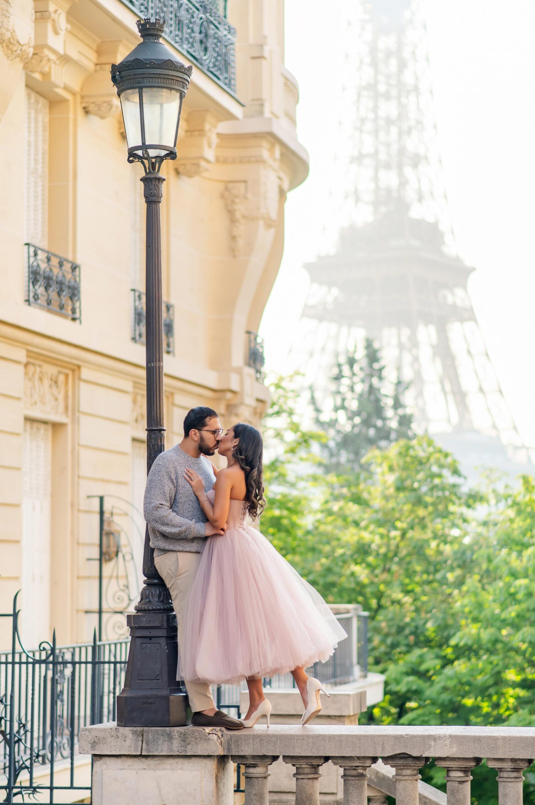 Couple kissing at Avenue de Camoëns with Eiffel Tower during Paris photoshoot