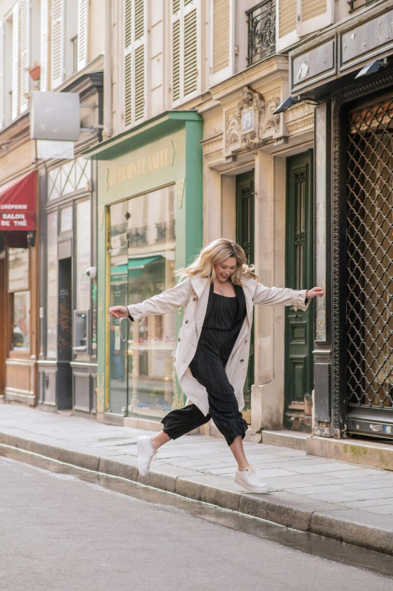 Woman jumping on Paris street during personal branding photoshoot